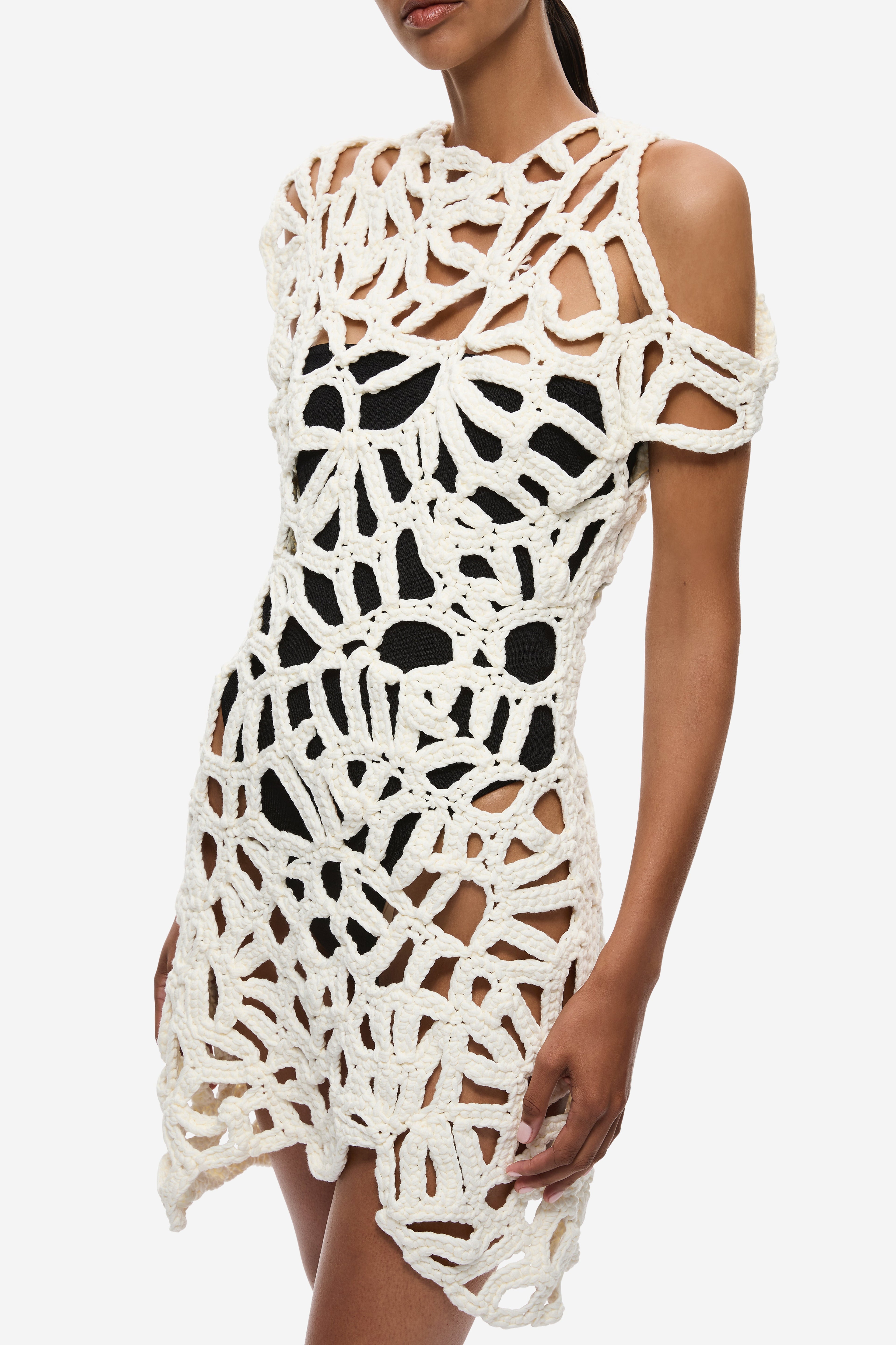 Ivory crochet mini dress bodice detail with bold openwork lattice and shoulder cutouts