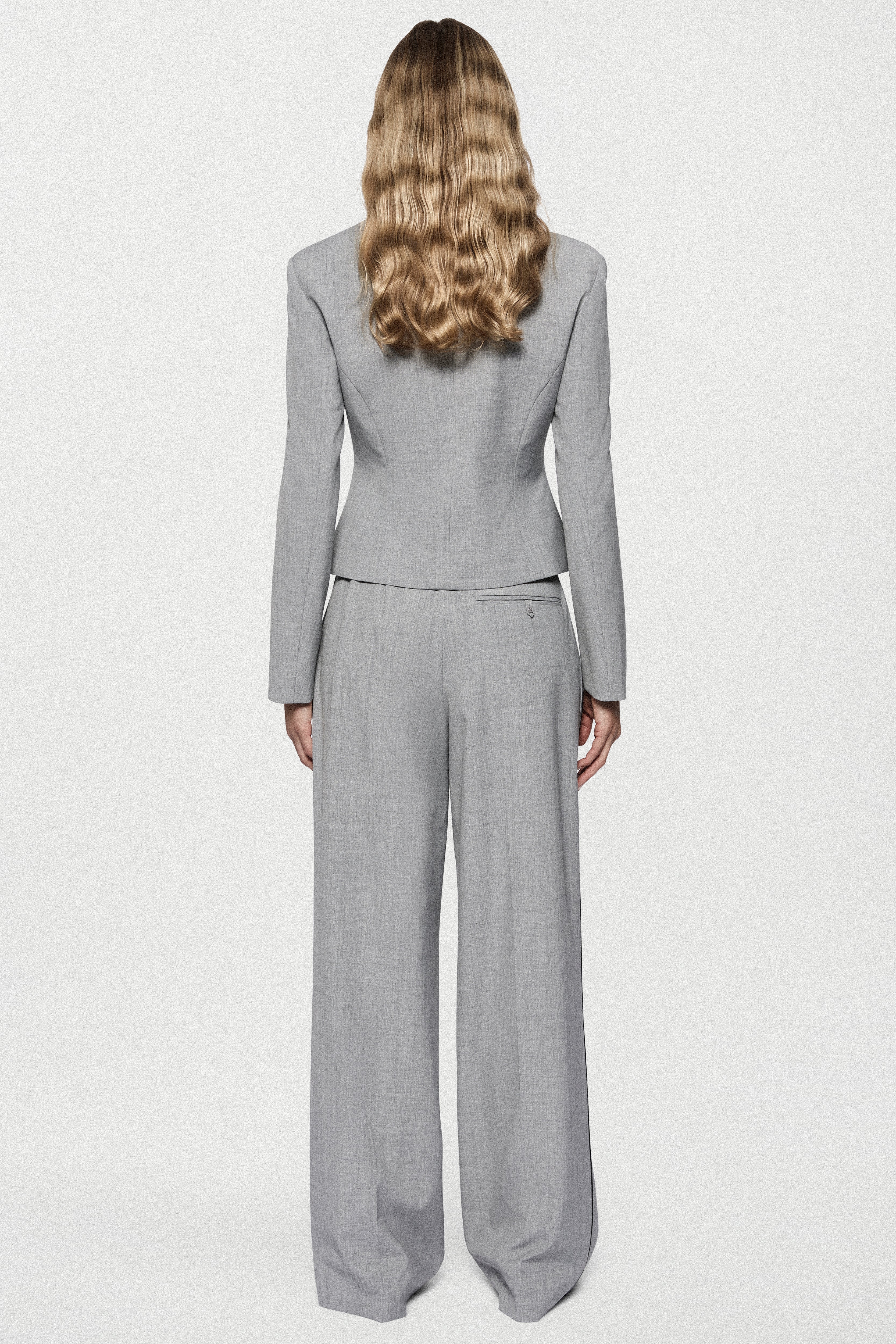 Melange grey wide-leg trousers, back view with seam detailing