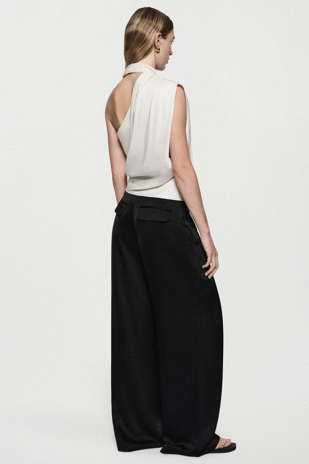 Back view of winter white satin sleeveless drape top