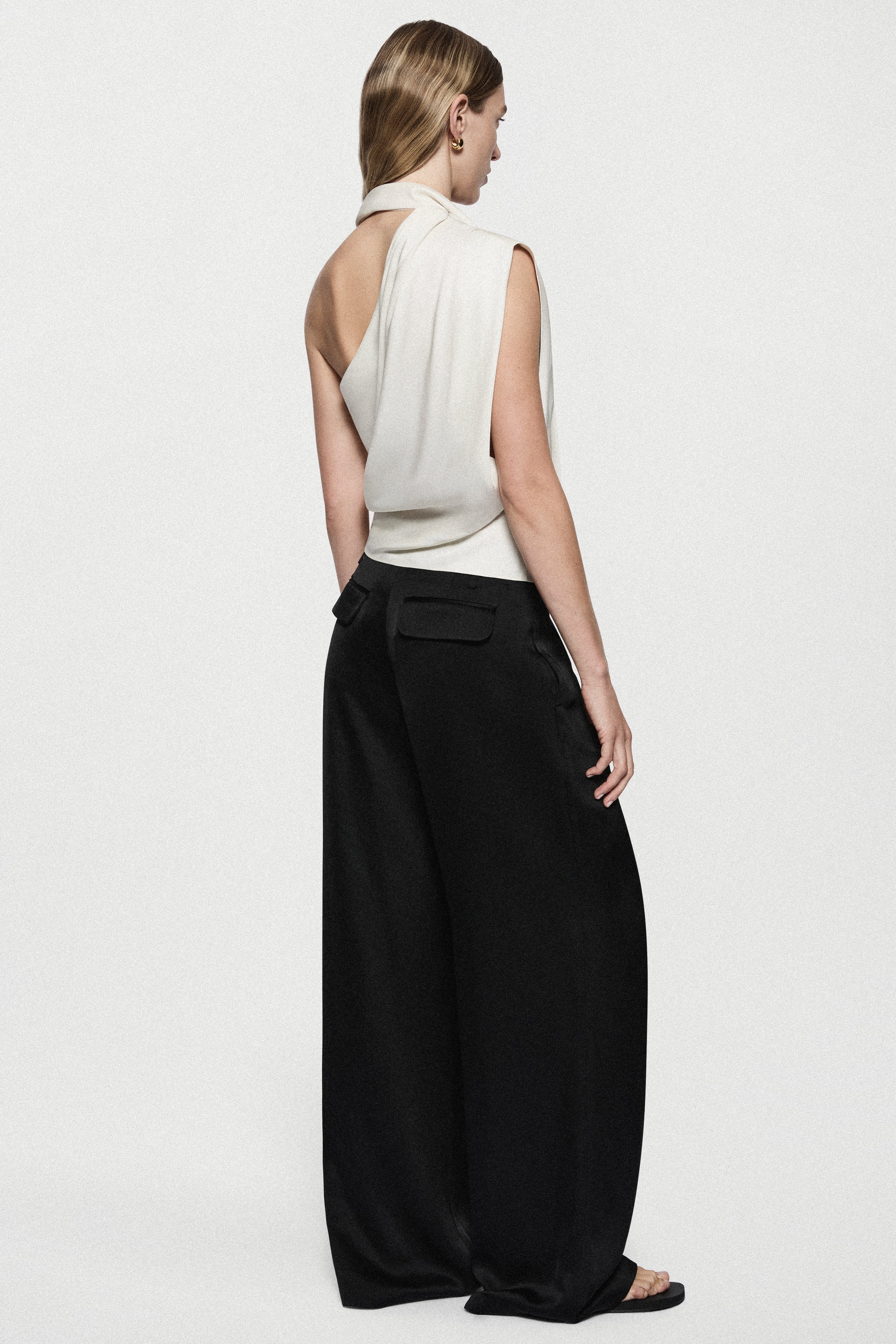 Back view of winter white satin sleeveless drape top