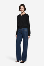 Black knit cardigan with four-button front and long sleeves, ribbed cuffs