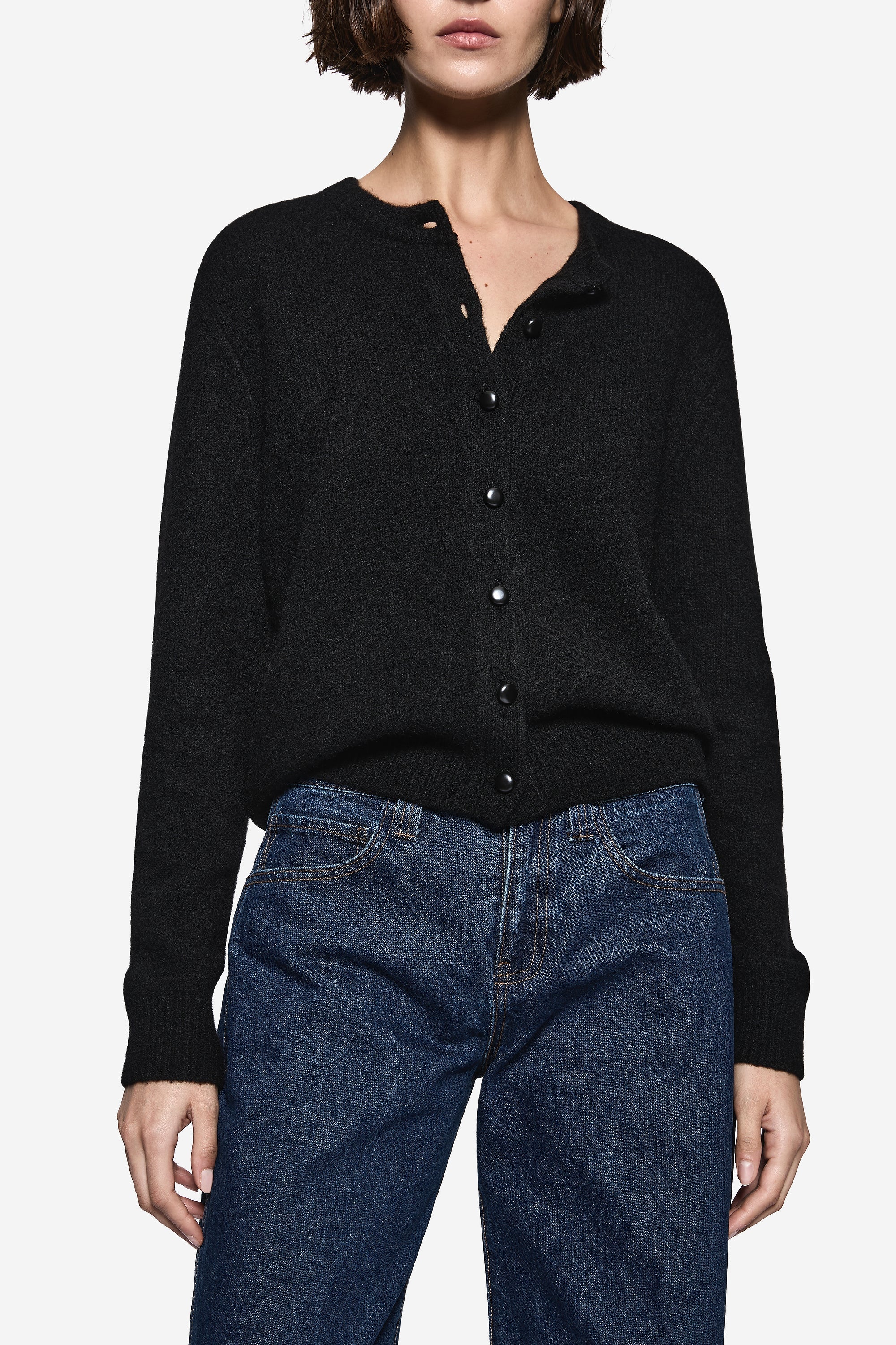 Black cardigan sweater with button-front placket, long sleeves, ribbed cuffs and hem