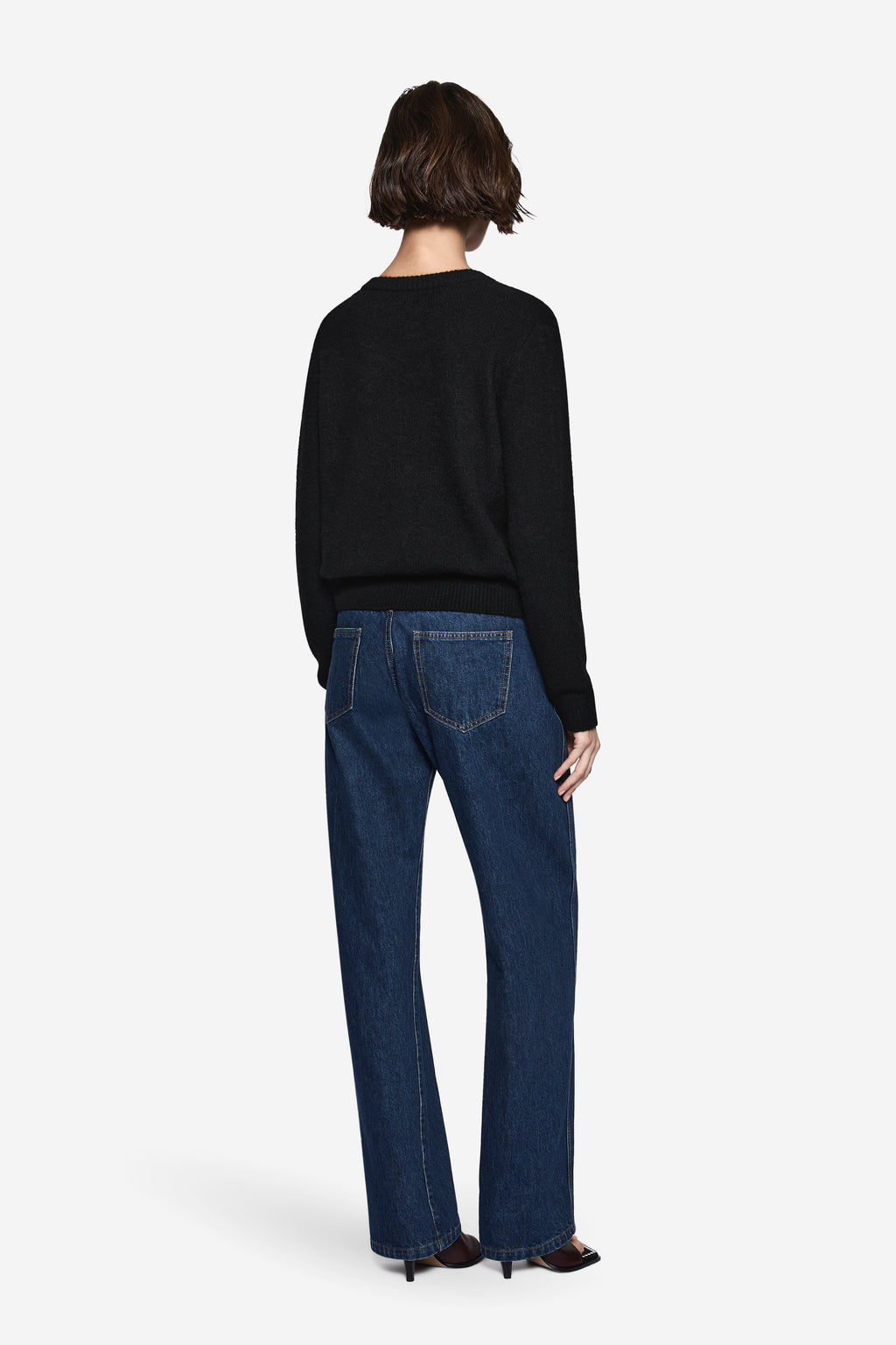 Black knit cardigan back view with long sleeves and ribbed hem