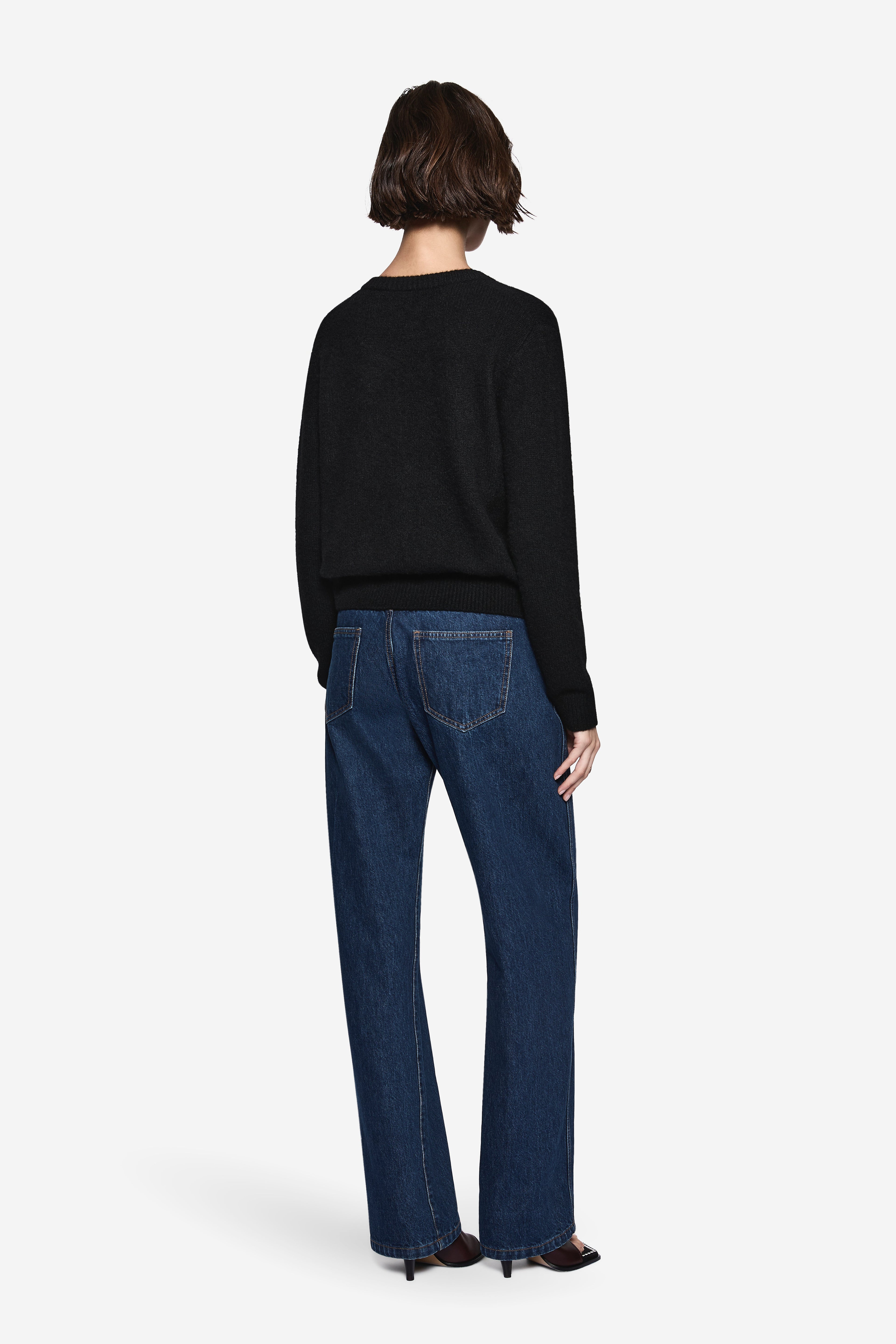 Black knit cardigan back view with long sleeves and ribbed hem