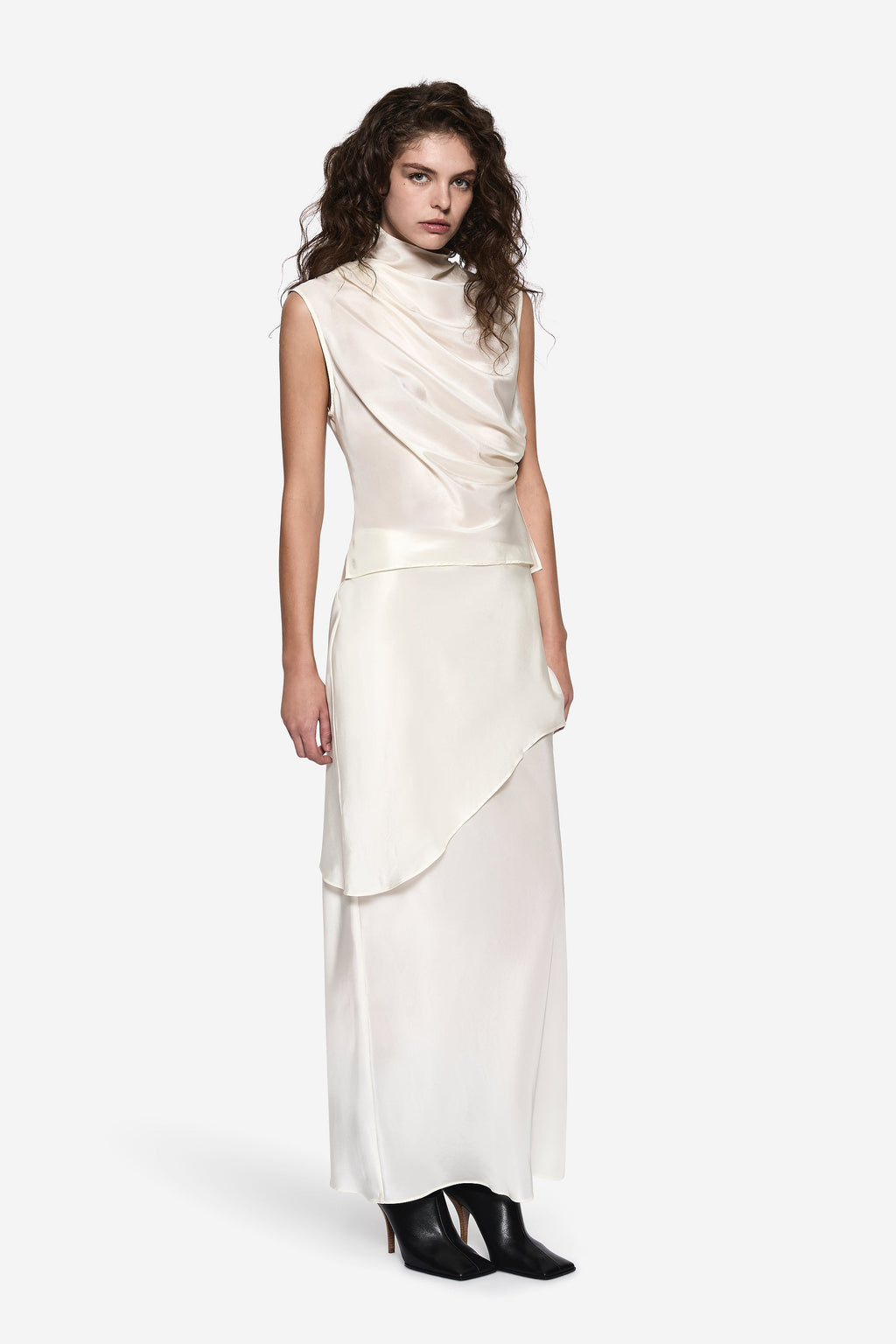 Off-white sleeveless silk top with high cowl neckline and asymmetric drape hem