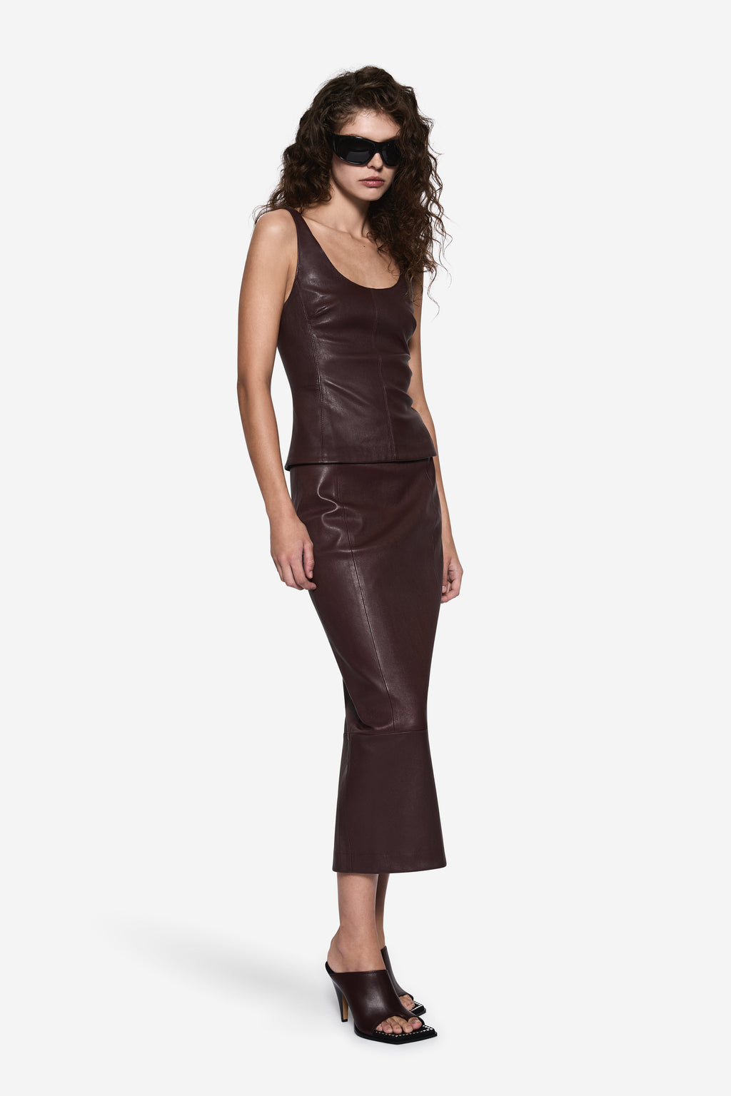 Dark brown sleeveless stretch leather top with scoop neck and straight fitted hem