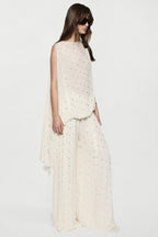 Sleeveless winter white rhinestone dot top with straight neckline and airy fit