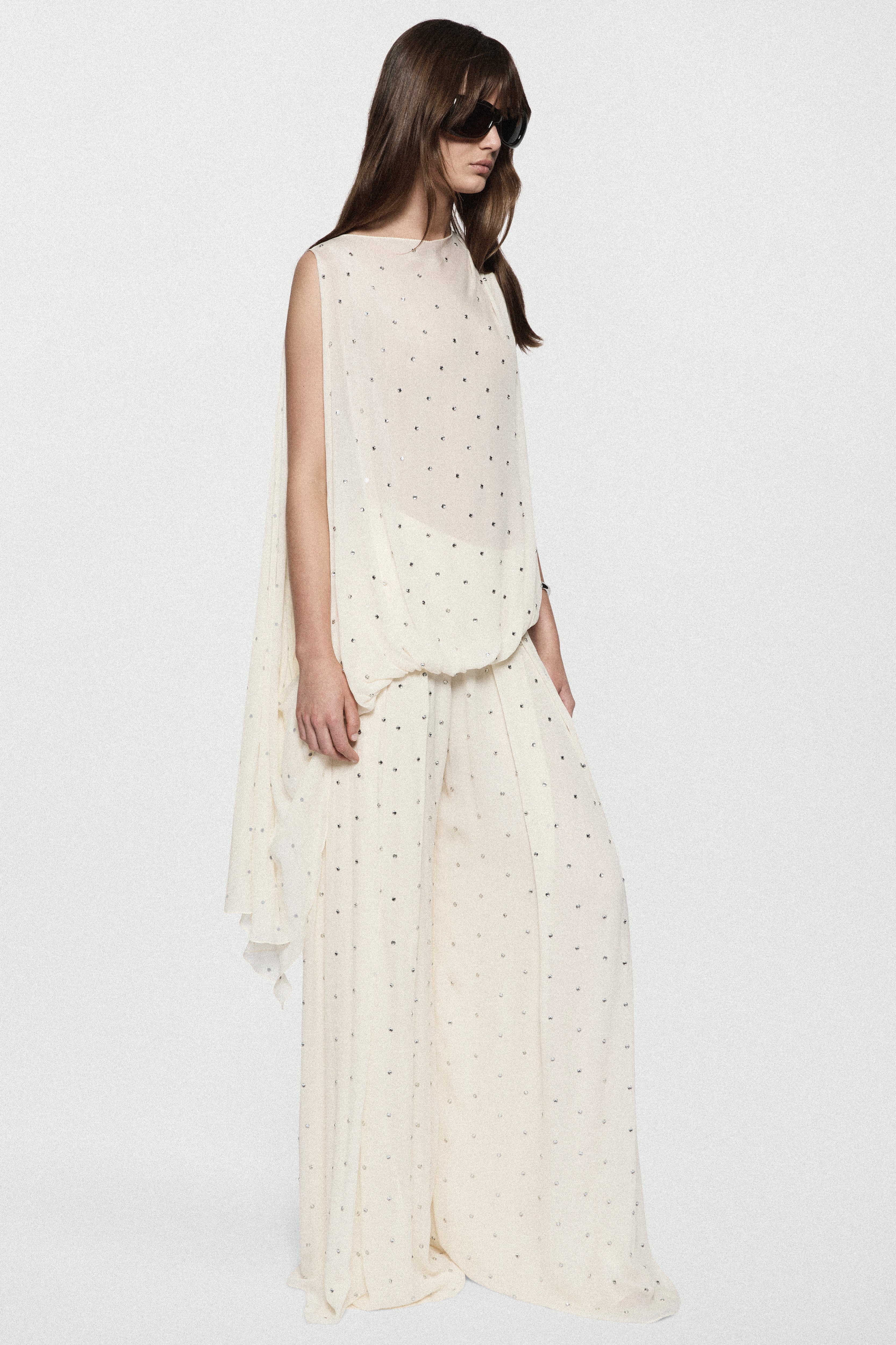 Sleeveless winter white rhinestone dot top with straight neckline and airy fit