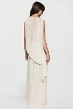 Back view of sleeveless winter white rhinestone dot asymmetric top with drape