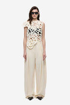 Ivory crochet top with openwork floral pattern and scalloped edges, cap sleeves