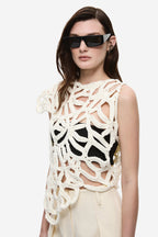 Ivory crochet top close-up with bold openwork loops and scalloped shoulder detail