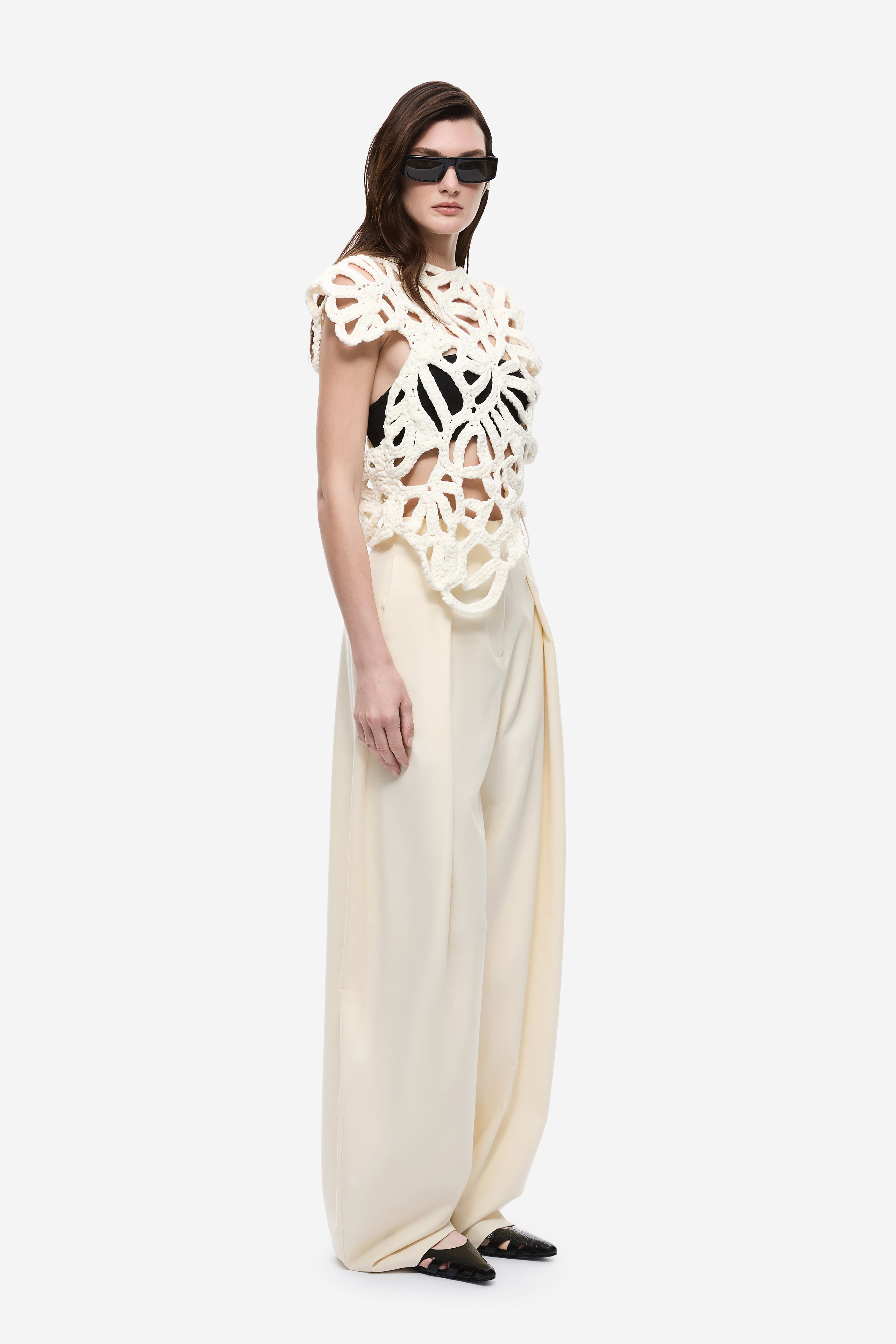 Ivory crochet top with intricate openwork pattern and crew neck, short cap sleeves