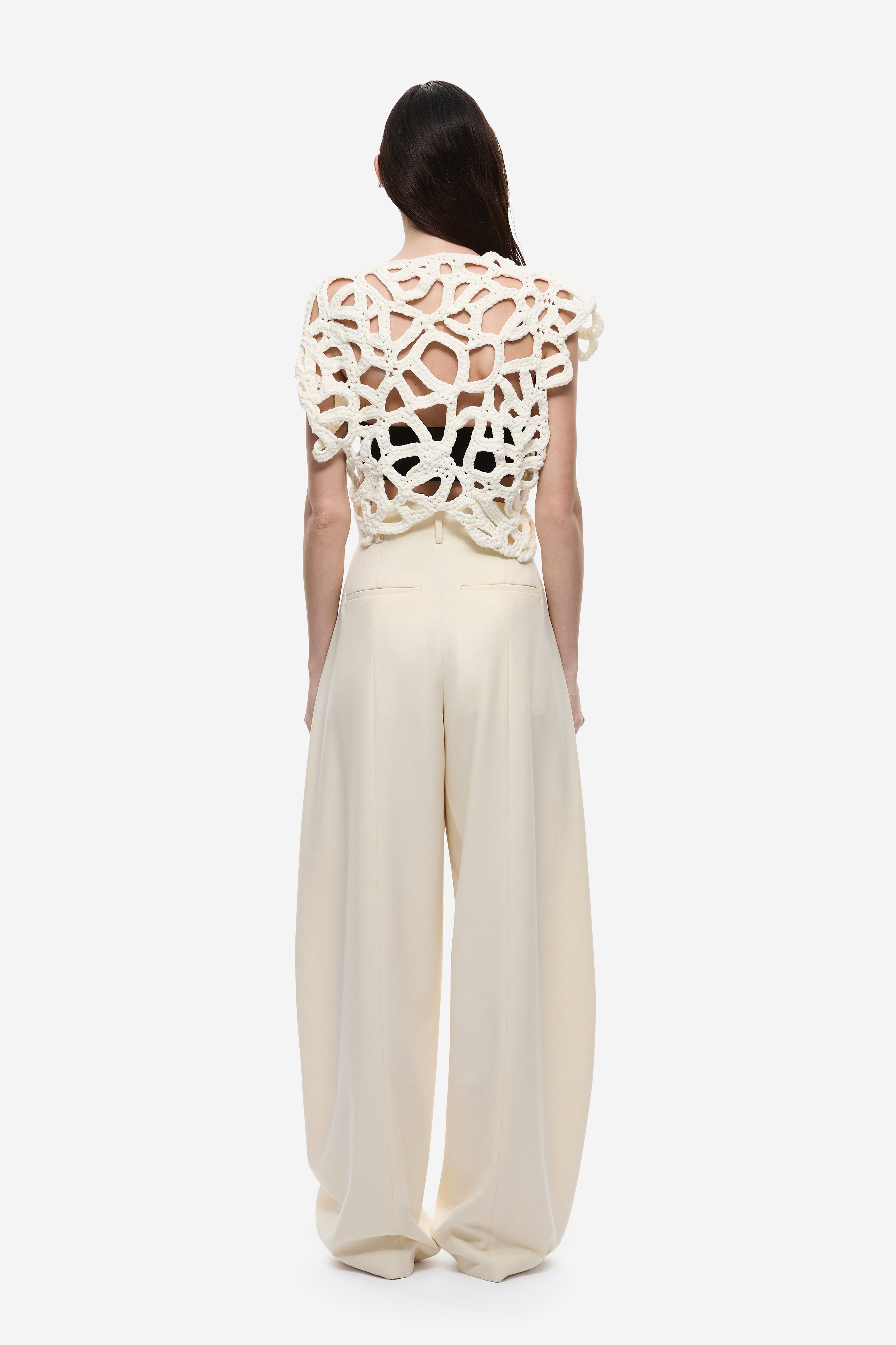 Ivory crochet top back view with openwork lace pattern and curved hem