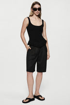 Black twill acetate shorts with elastic waist and wide legs, above-knee length