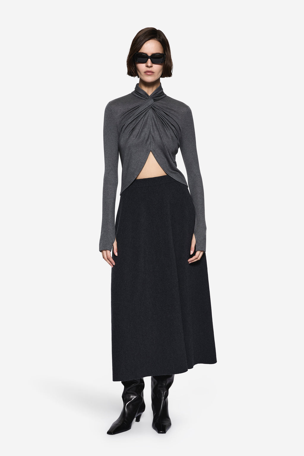 Dark charcoal TENCEL long-sleeve twist top with draped front and side slit.
