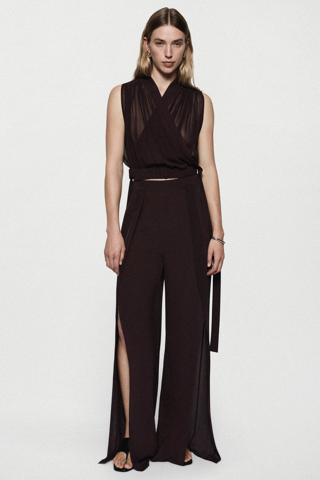 Silk split-leg pants in deep fig with V-neck wrap bodice, tied waist, side slits