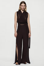 Silk split-leg pants in deep fig with V-neck wrap bodice, tied waist, side slits