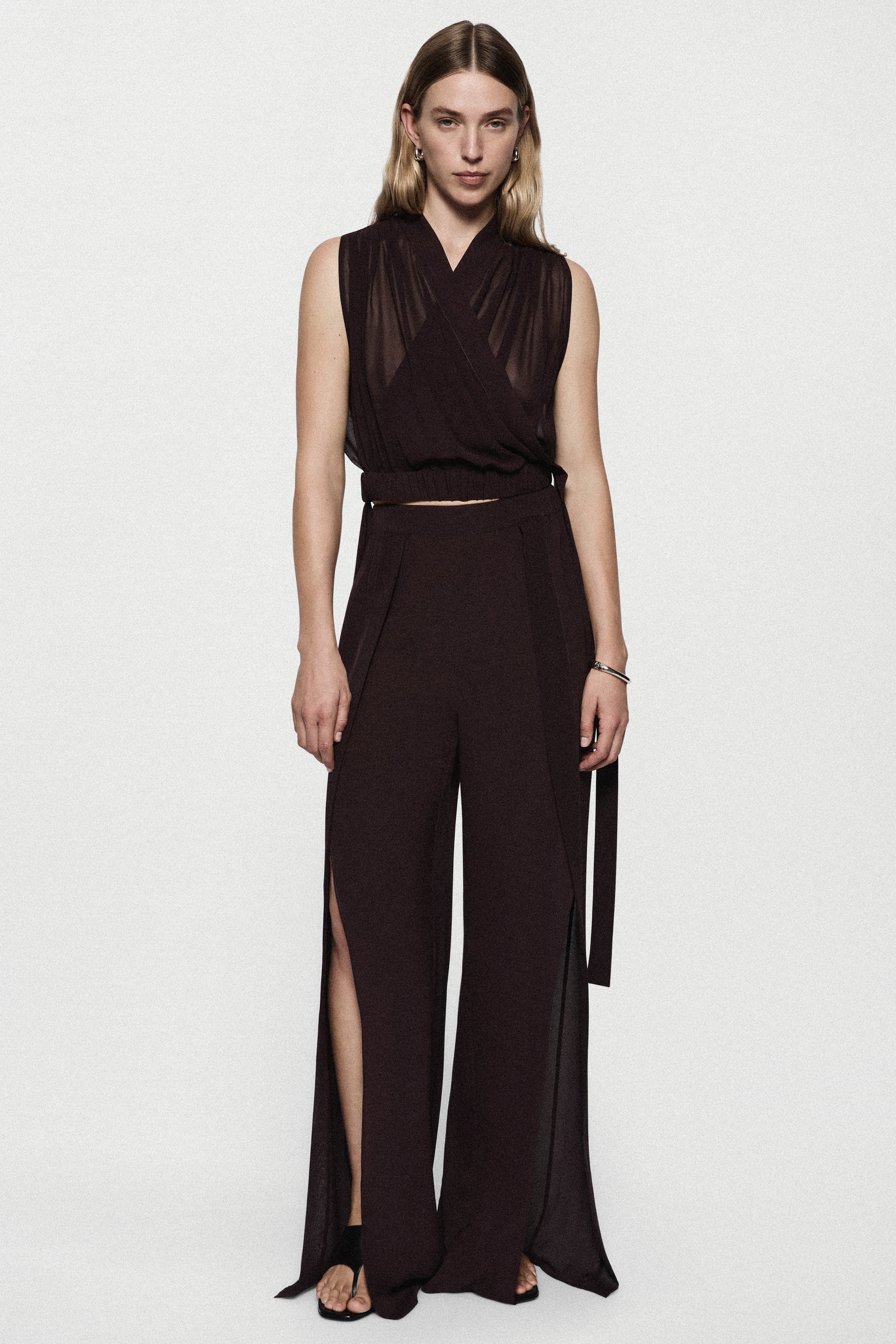 Silk split-leg pants in deep fig with V-neck wrap bodice, tied waist, side slits