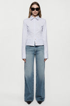 High-rise vintage wash wide-leg jeans in faded denim, button closure