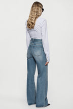 High-rise vintage wash wide-leg jeans from back view, light-blue faded denim, wide leg