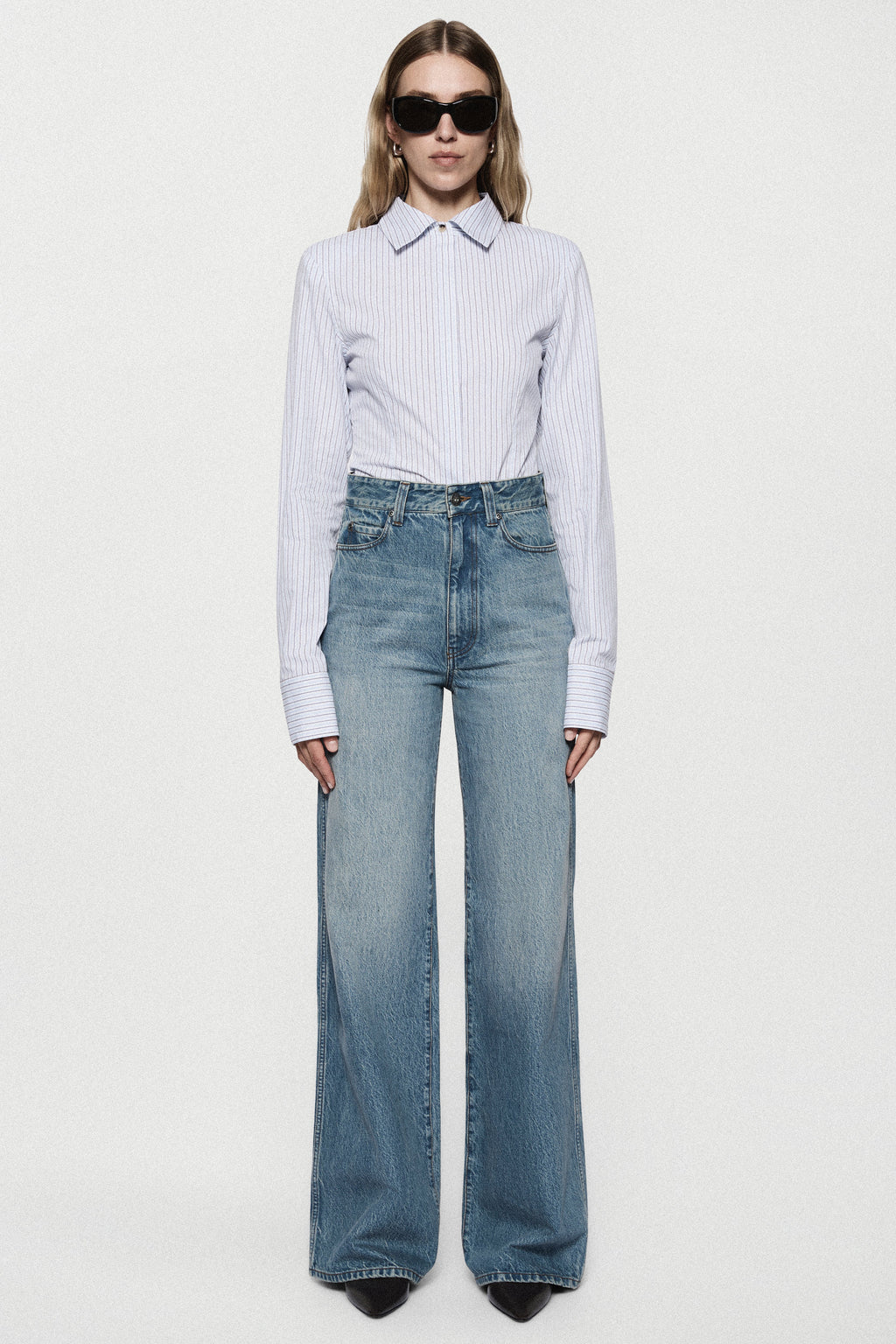 High-rise vintage wash wide-leg jeans with light-blue faded denim and front seams