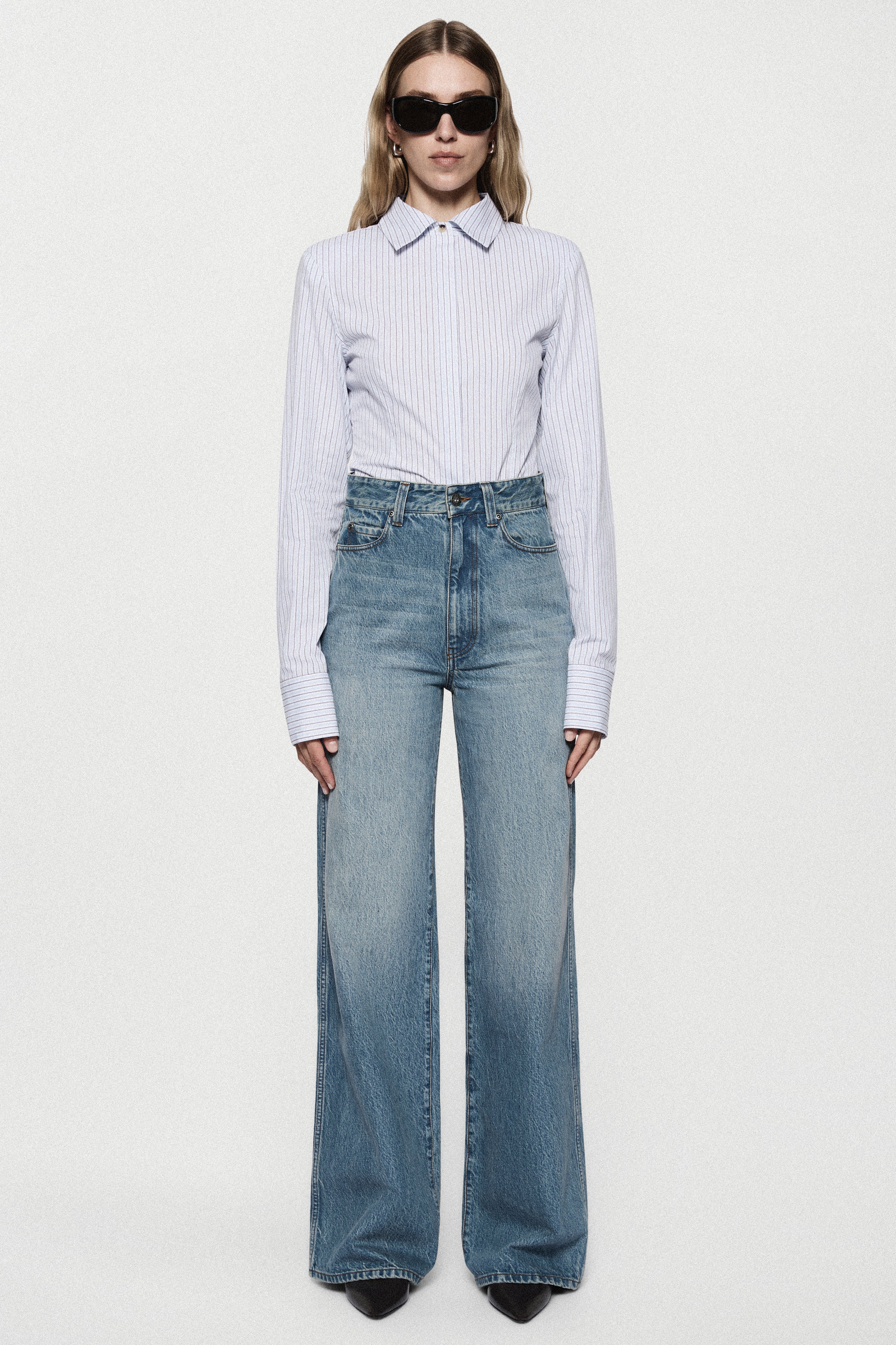 High-rise vintage wash wide-leg jeans with light-blue faded denim and front seams