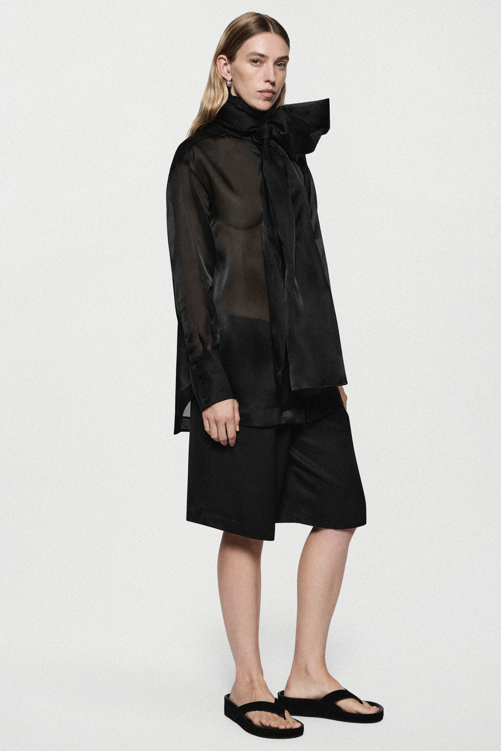 Black silk organza blouse with high collar bow and relaxed long sleeves