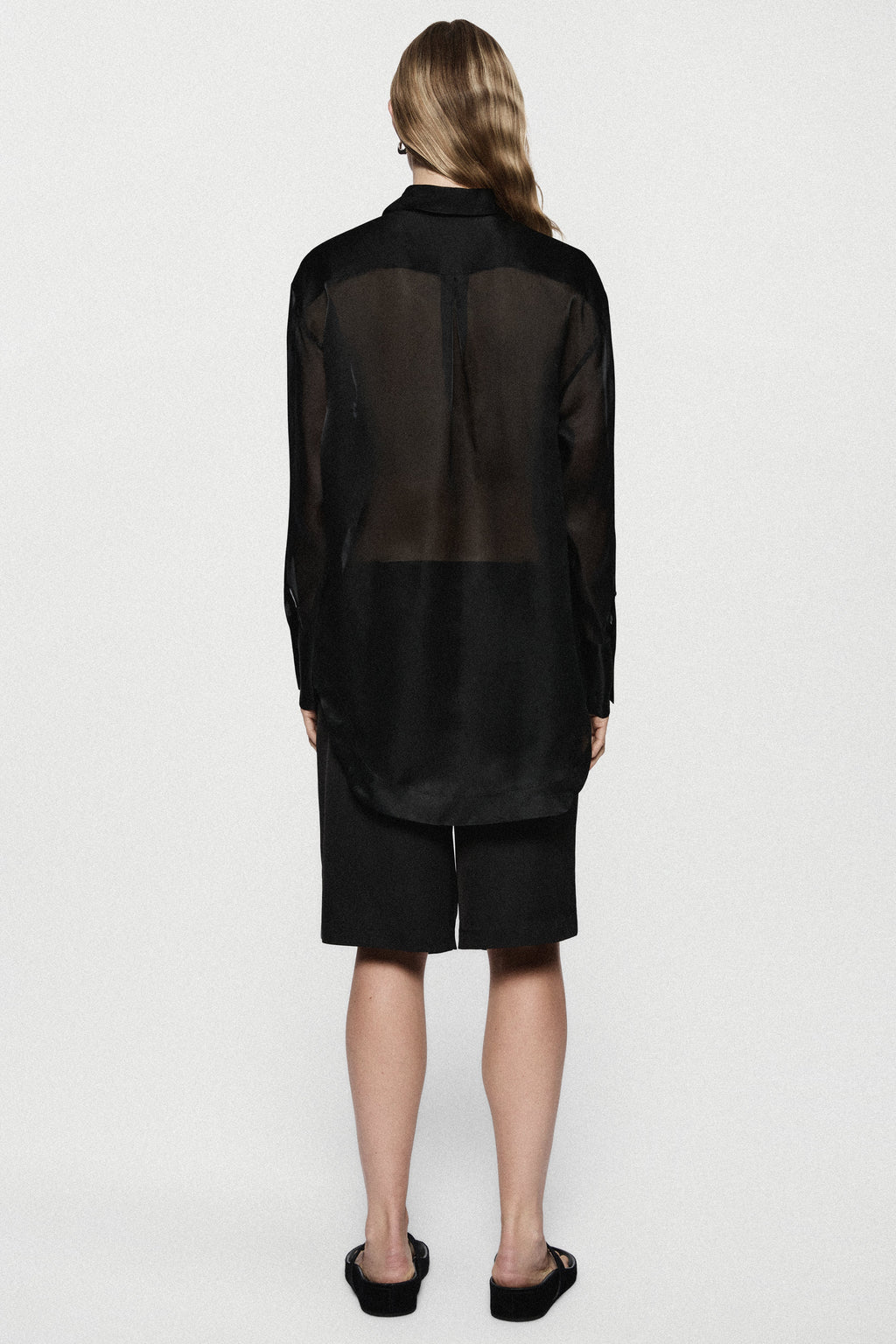 Black silk organza blouse back view with sheer panel and long sleeves