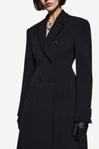 Black notch-collar coat close-up with double-breasted buttons and structured lapels