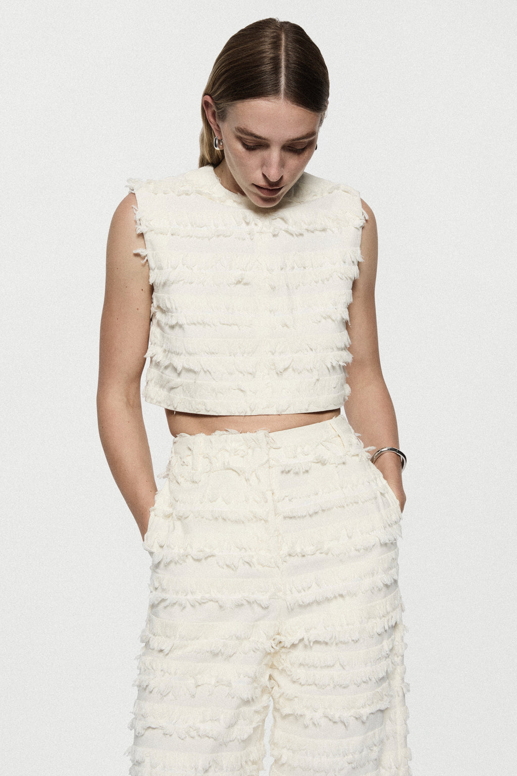 Winter white cotton fringe pants with ruffled tiers and wide waistband