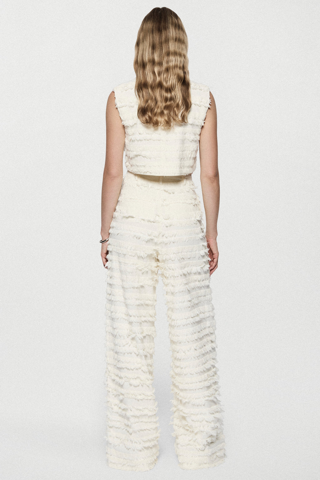 Winter white cotton fringe wide-leg pants with ruffled horizontal rows, back view