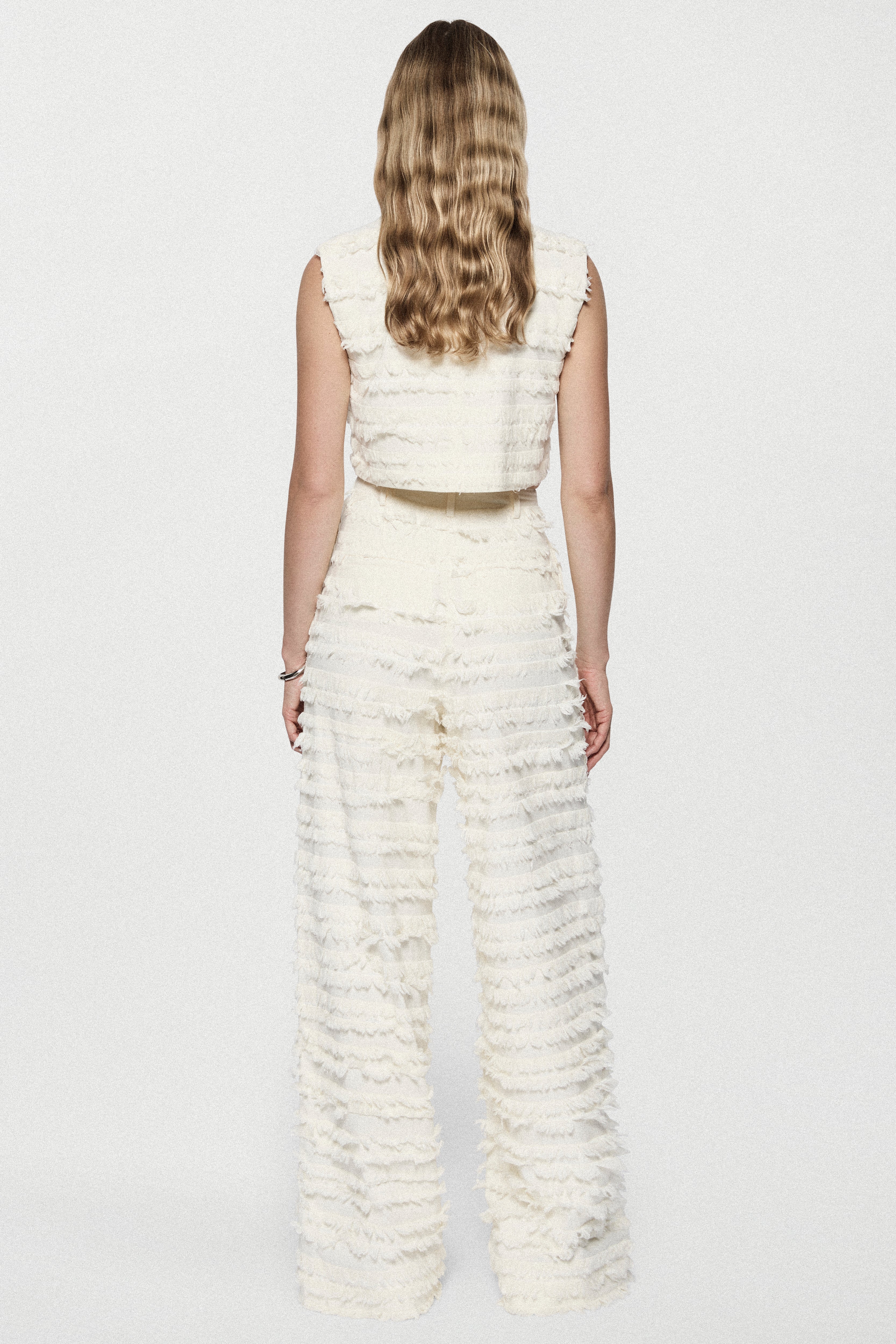 Winter white cotton fringe wide-leg pants with ruffled horizontal rows, back view