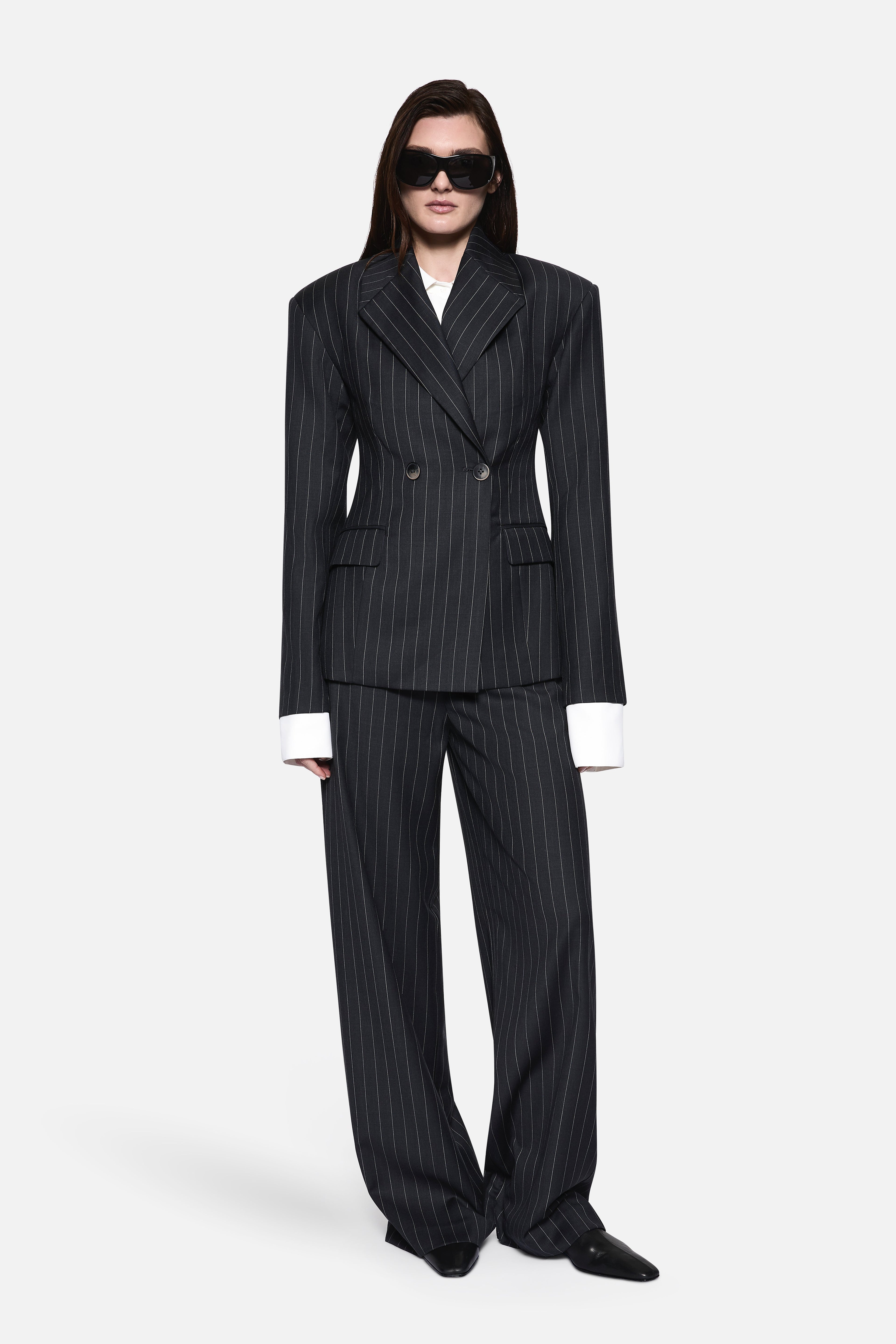 Charcoal pinstripe wool blazer with button front, notch lapels, and flap pockets.