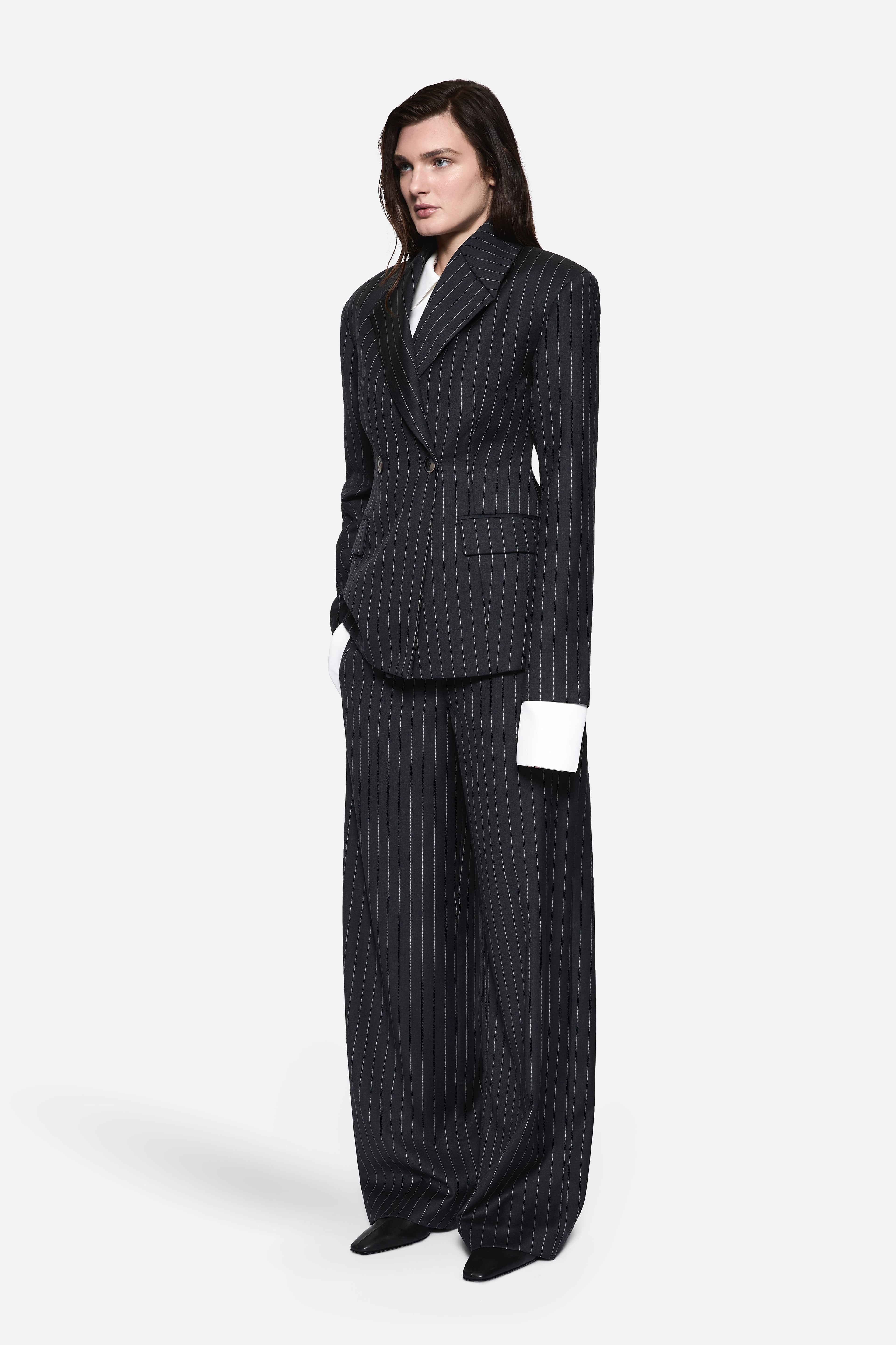 Charcoal pinstripe wool blazer with tailored button front and structured shoulder seams.