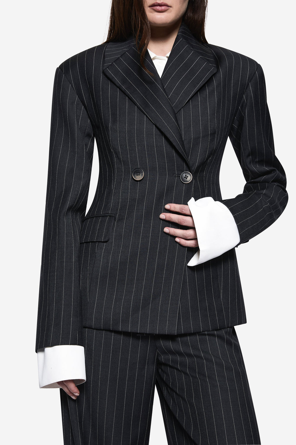 Charcoal pinstripe wool blazer close-up with button front, long sleeves, and flap pockets.