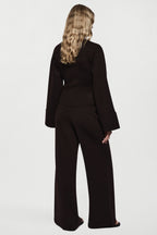 Women’s merino wide-leg pants in dark brown, back view with relaxed waistband