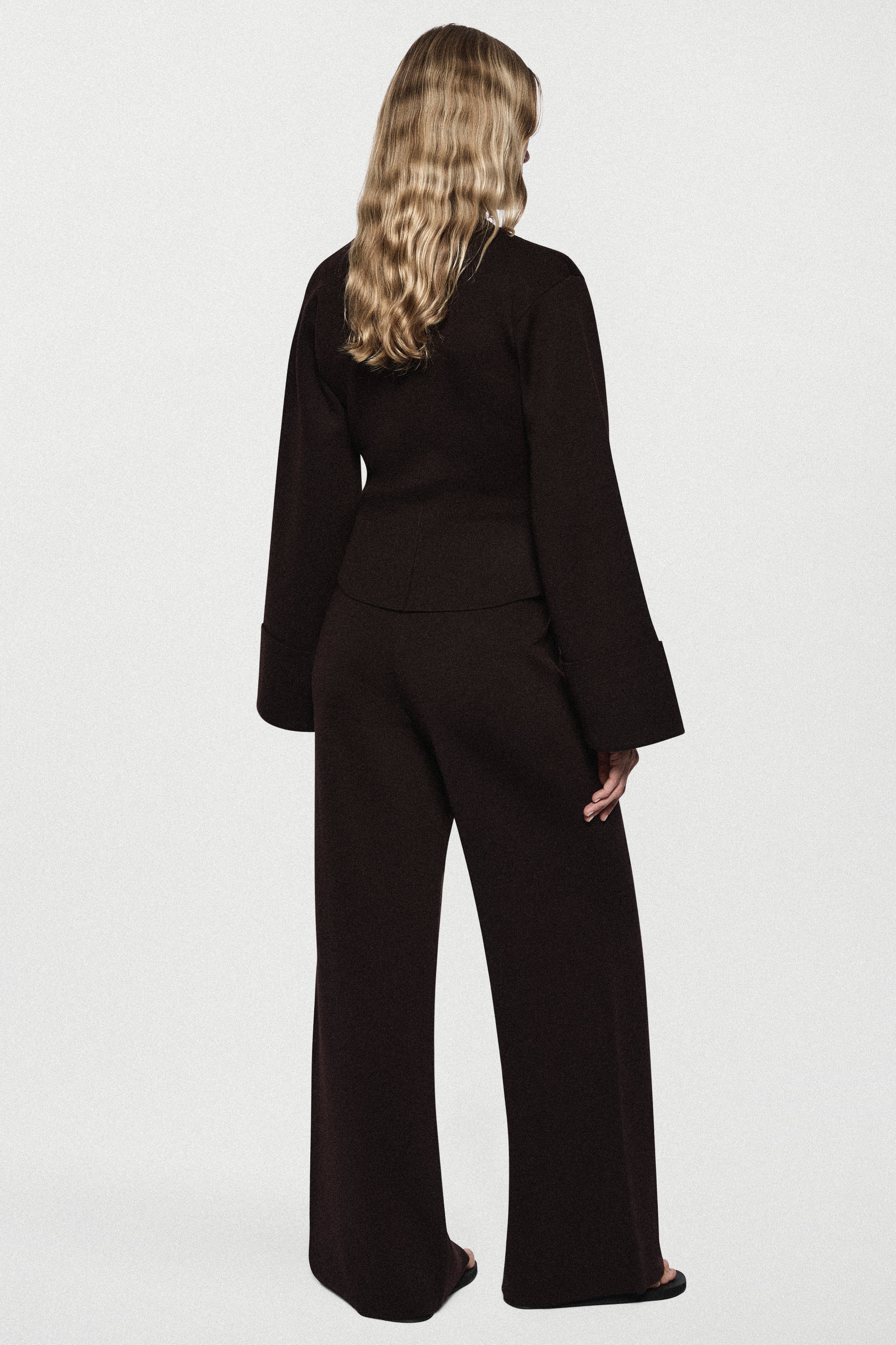Women’s merino wide-leg pants in dark brown, back view with relaxed waistband