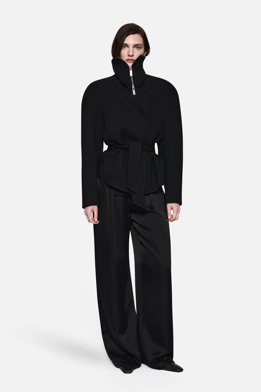 Black acetate collared jacket with stand collar, zip front, belted waist, peplum hem.