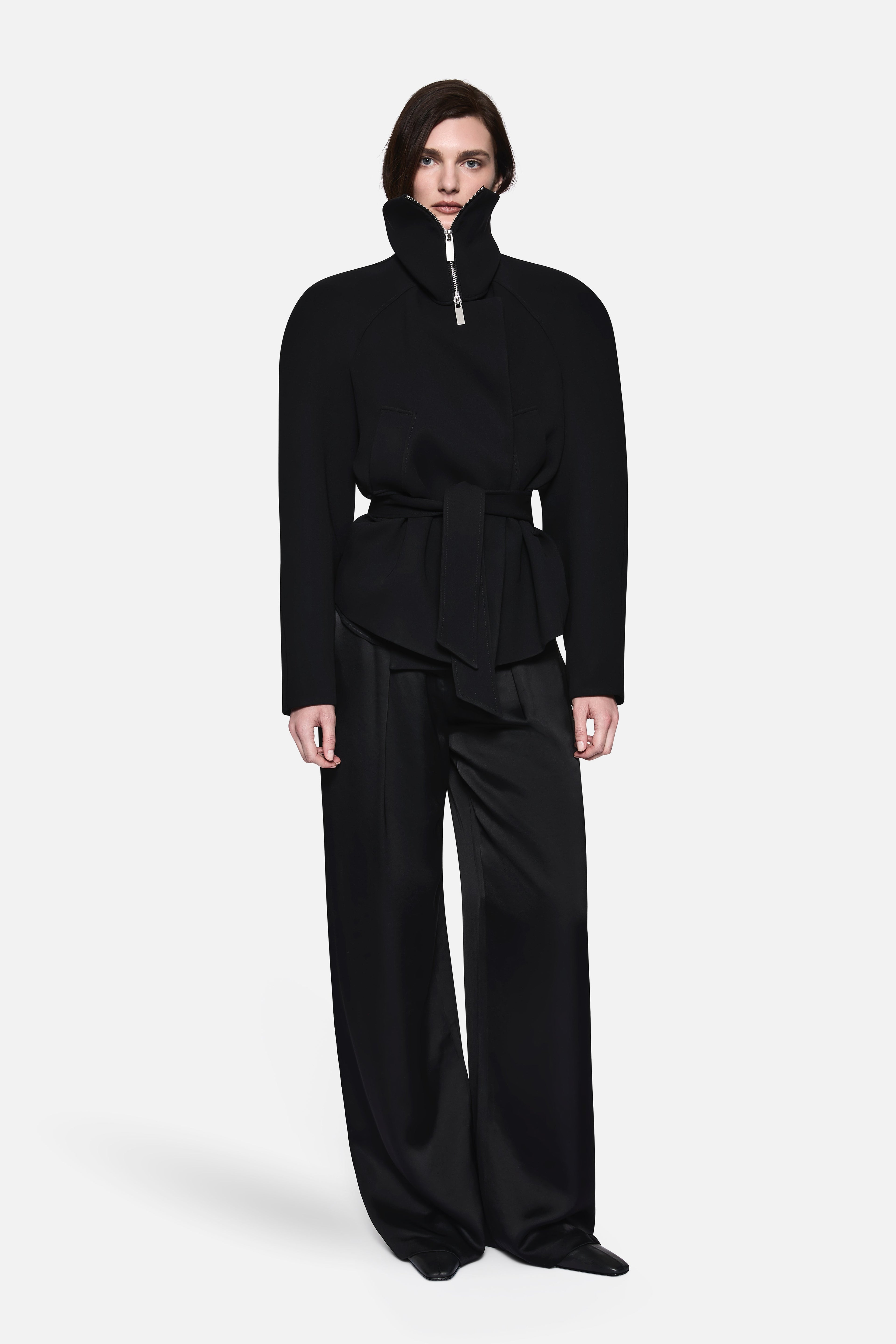 Black acetate collared jacket with stand collar, zip front, belted waist, peplum hem.