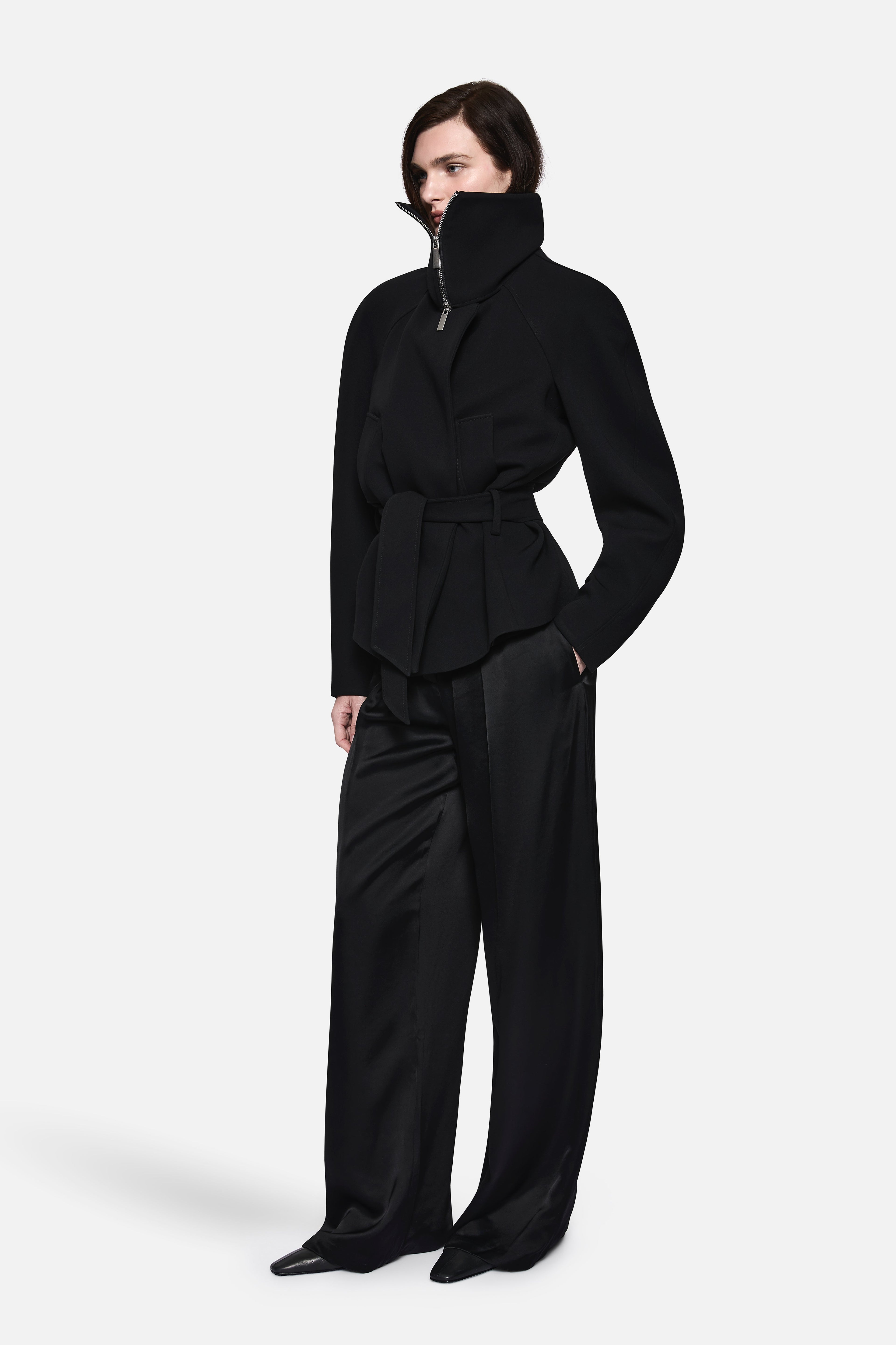 Black acetate collared jacket with stand collar, zip closure, and belted peplum waist.