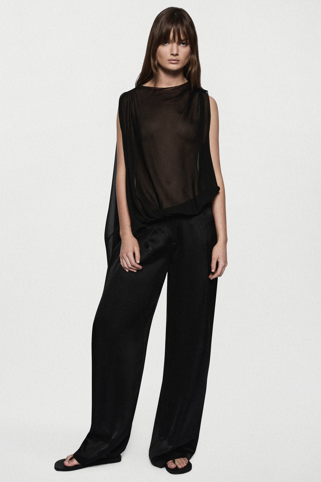 Black sheer sleeveless silk blouse with high neck and relaxed draped fit