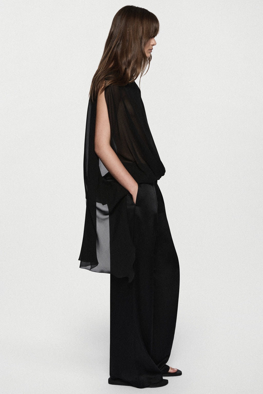 Black sheer sleeveless silk blouse with high neck and back tie detail