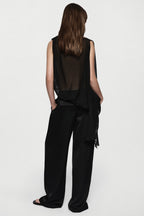 Back view of black sheer sleeveless silk blouse with high neck and waist ties