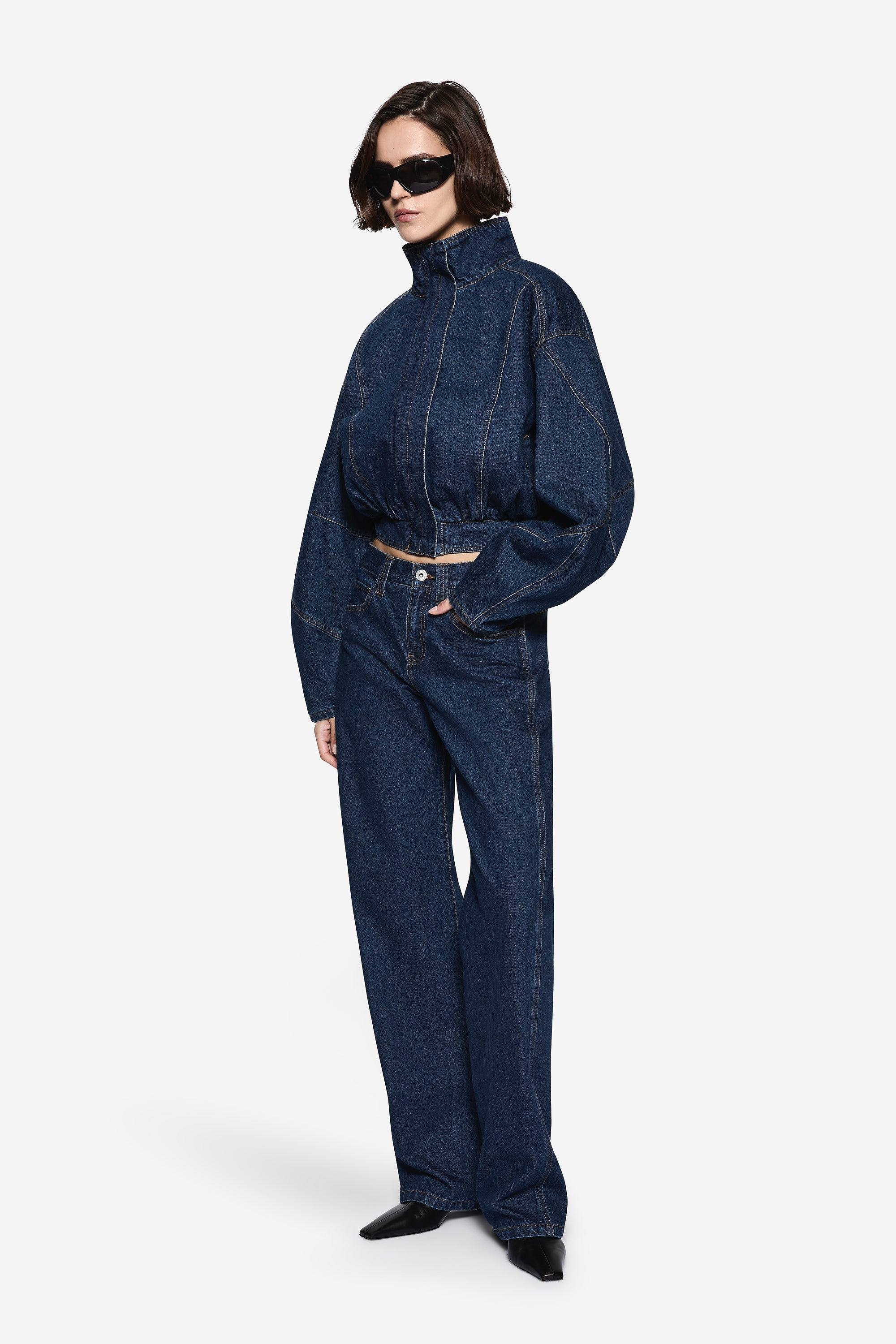 Vintage blue denim jacket with high collar and full zipper, relaxed shoulders
