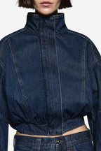 Vintage blue denim jacket close-up with high neck and zip seam detailing
