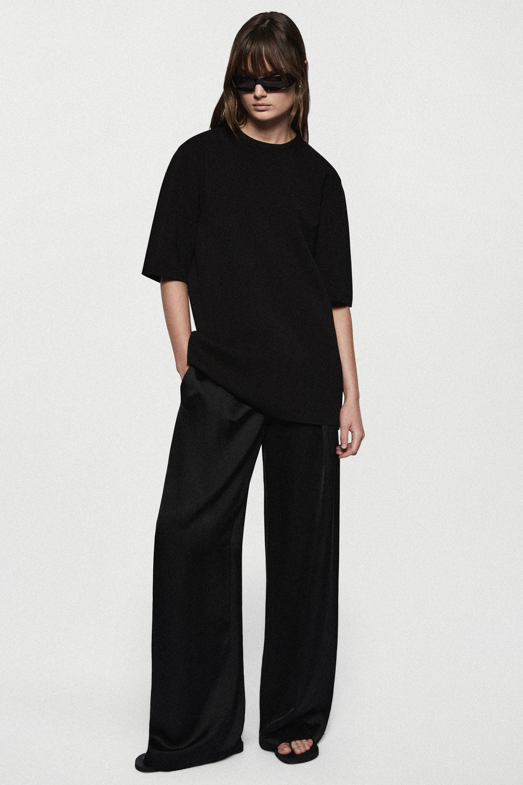 Black oversized knit tee with short sleeves and relaxed crew neckline
