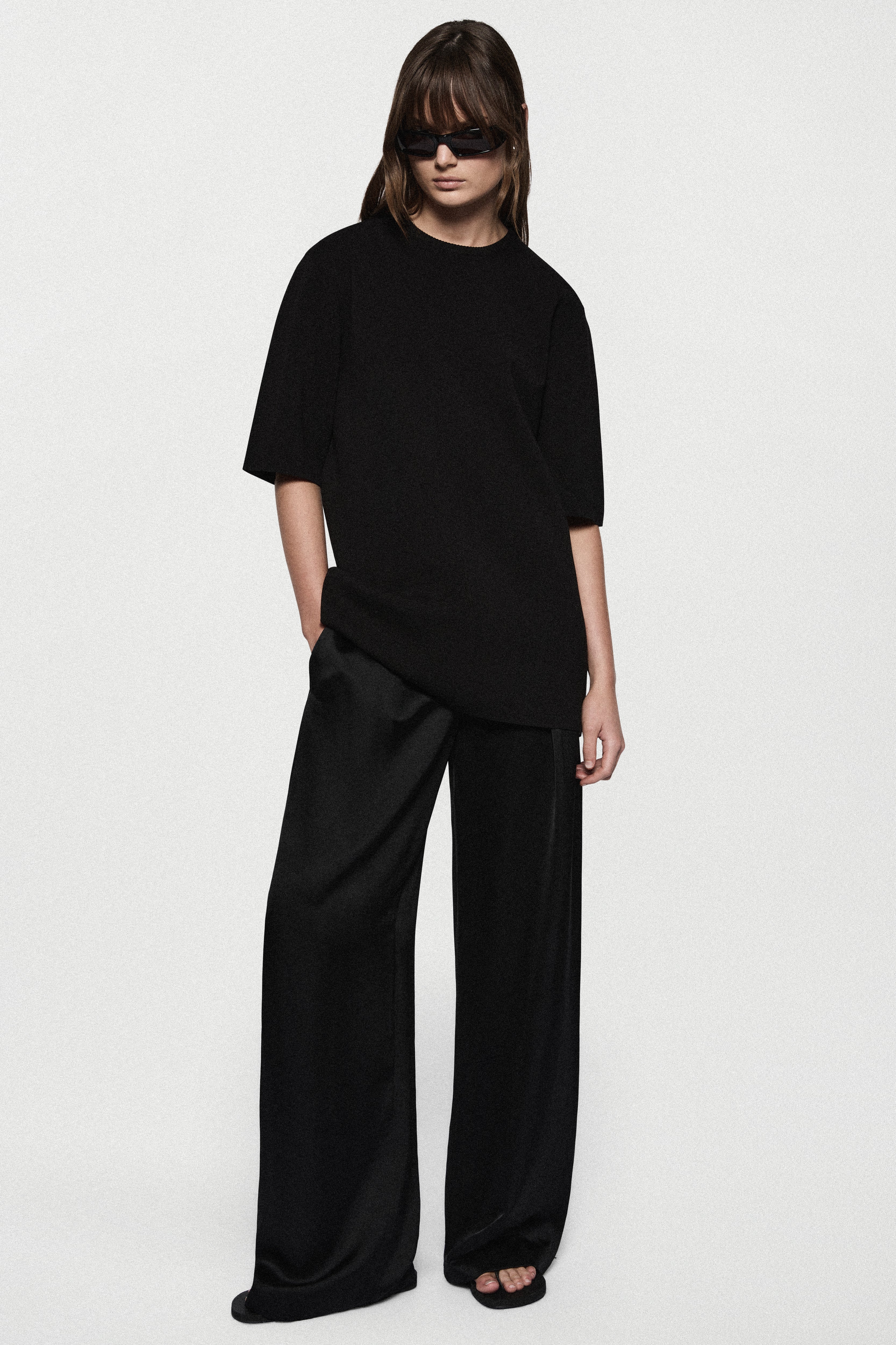 Black oversized knit tee with short sleeves and relaxed crew neckline