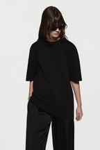 Black oversized knit tee with crew neckline, short sleeves, relaxed fit