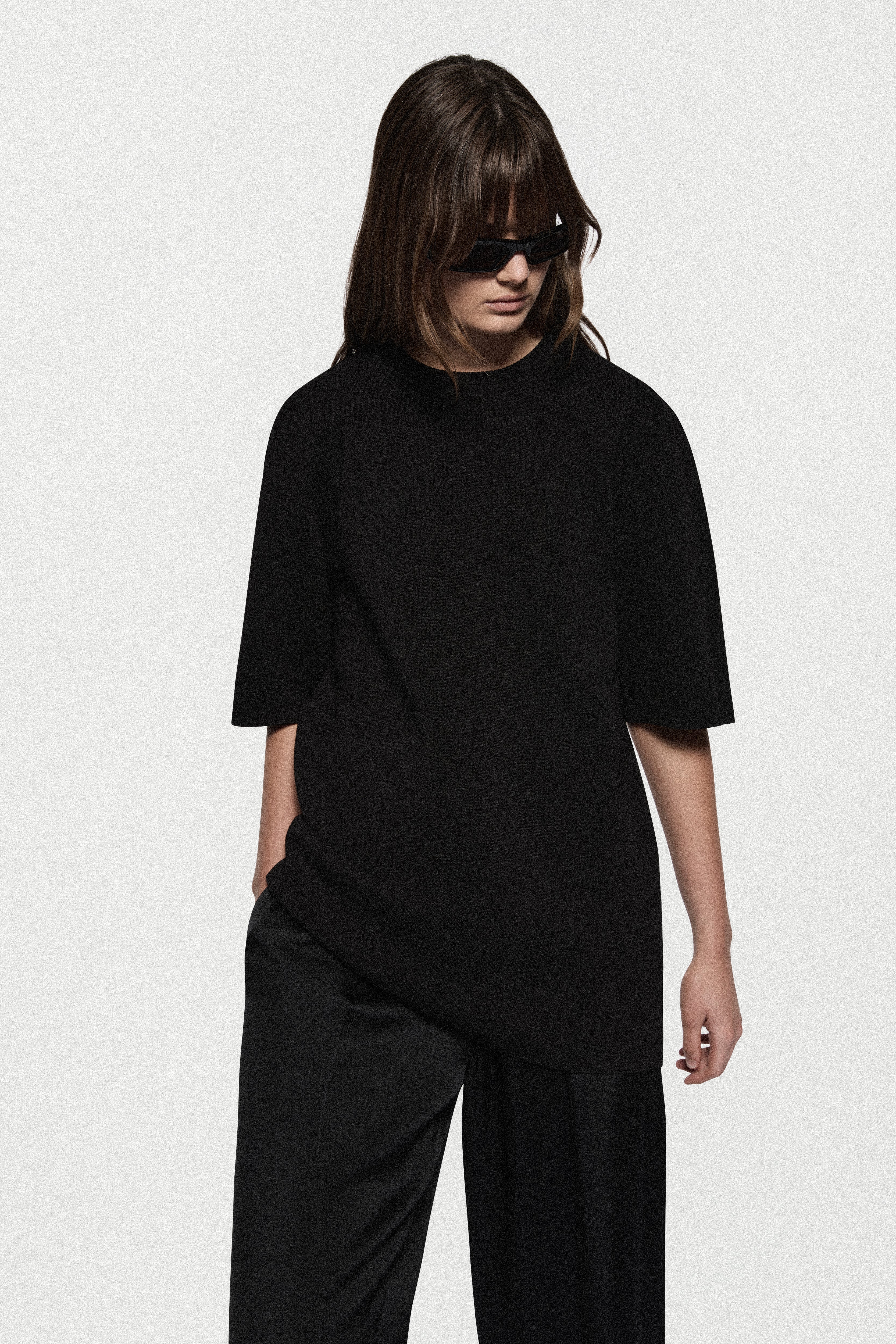 Black oversized knit tee with crew neckline, short sleeves, relaxed fit