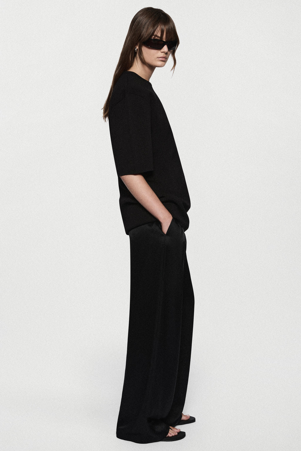 Black oversized knit tee in relaxed side profile with short sleeves